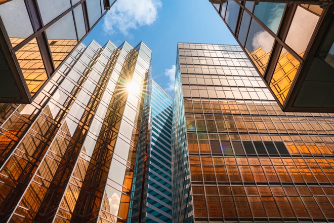 Image of skyscrapers in city, viewpoint looking up into the sky.