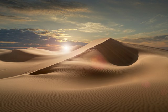 Sand dunes in a desert at sunset