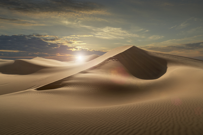 Sand dunes in a desert at sunset