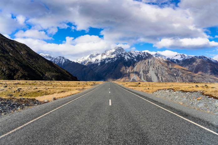 Picture of a long straight road with the route heading towards a mountain range